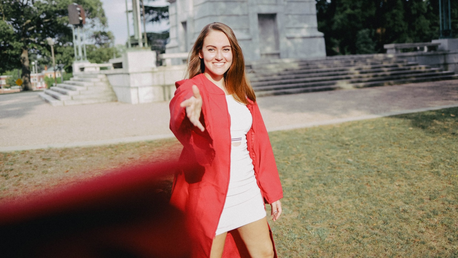 Graduate Maggie Jarrett tosses her cap toward the camera